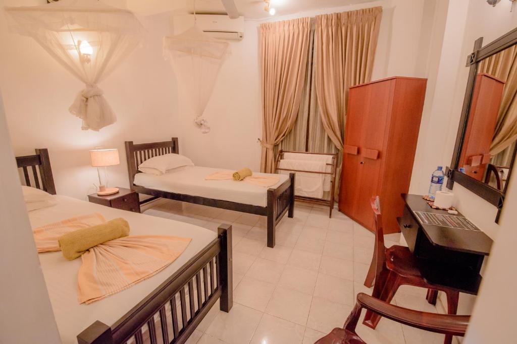 Postel nebo postele na pokoji v ubytování Muhsin Villa - Galle Fort