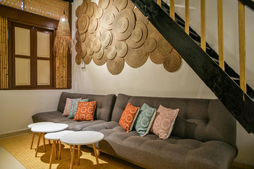 a living room with a couch and two tables at Ohana House @ 31 Jawa in Melaka