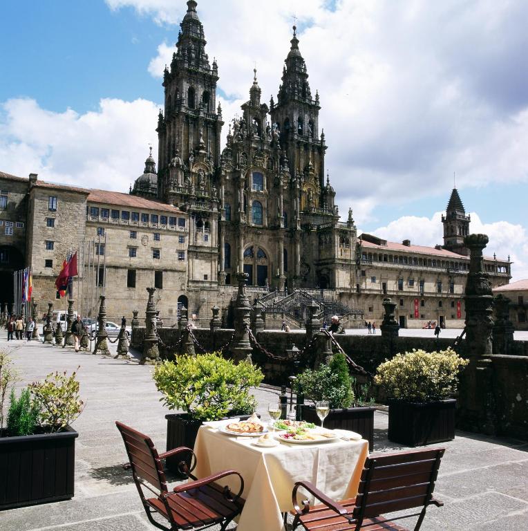 a table and chairs in front of a building at Parador de Santiago - Hostal Reis Catolicos in Santiago de Compostela