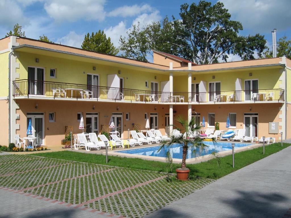 a villa with a swimming pool and a resort at Beach Hotel in Si&oacute;fok
