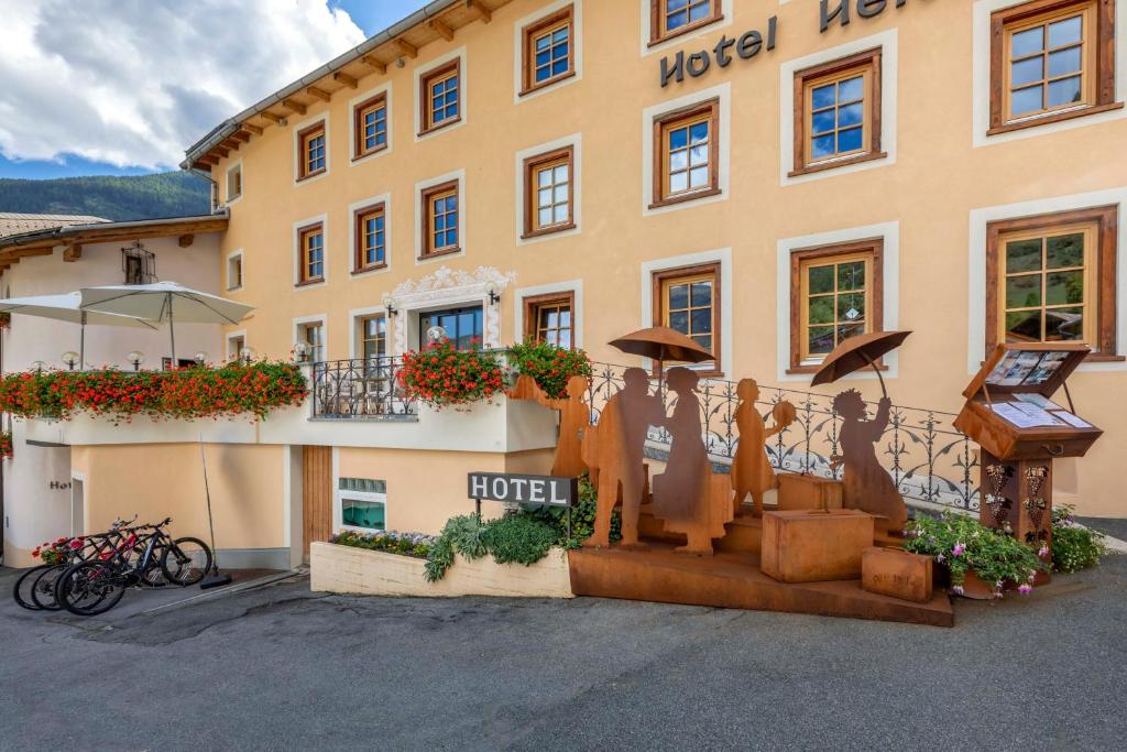 a hotel with a sign on the side of it at Hotel Helvetia in Müstair