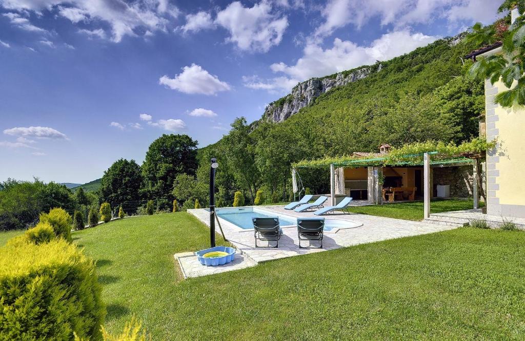 un patio con 2 sillas y una piscina en Villa Bella, en Lupoglav