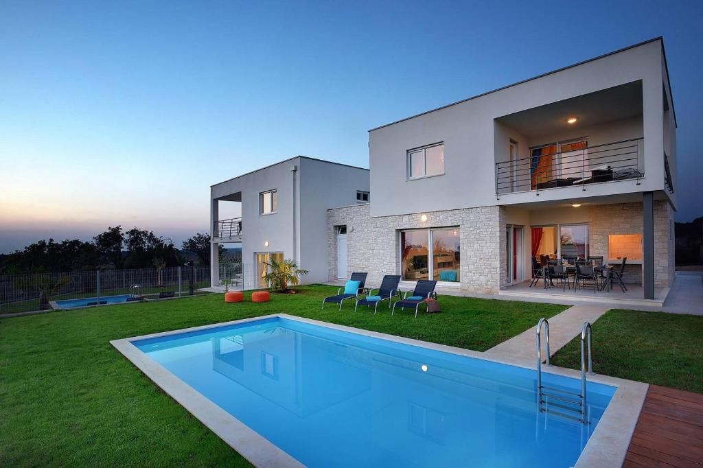 a house with a swimming pool in the yard at Villa Sky Dream in Bužinija