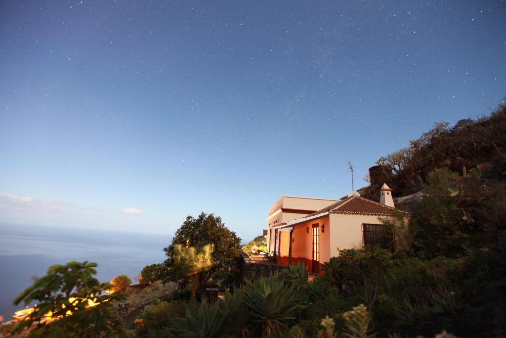 a house sitting on top of a hill at night at El Níspero in Fuencaliente de la Palma
