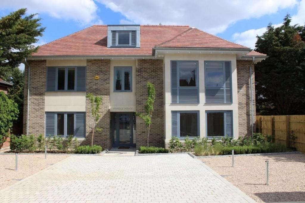 a brick house with a red roof at Citystay - Pringle House in Cambridge