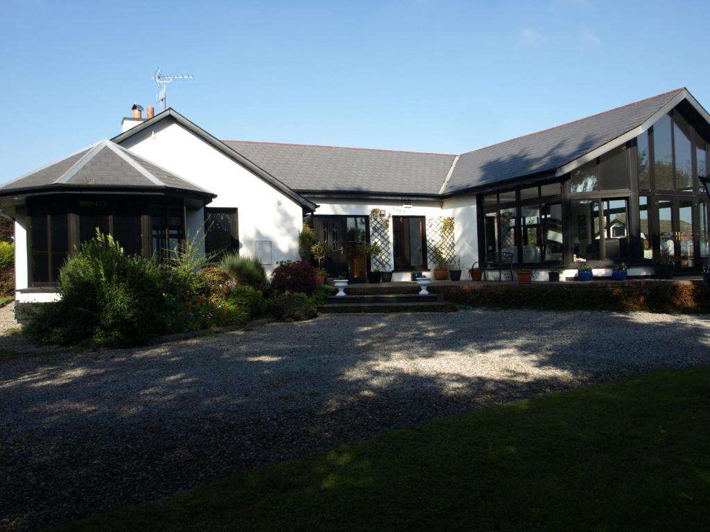 a large white house with a lot of windows at ocean view in Wexford