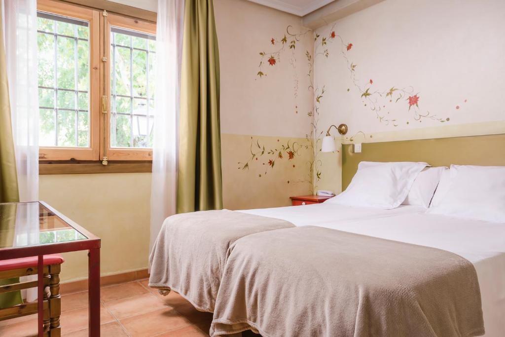 Postel nebo postele na pokoji v ubytování YIT Puerta Bisagra
