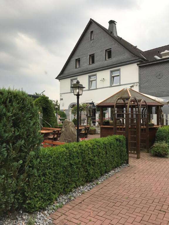 a house with a pavilion in front of it at Hotel Daun in Castrop-Rauxel