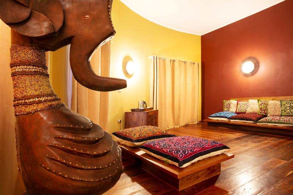 a room with an elephant statue in the middle of a room at Gold Zanzibar Beach House & Spa in Kendwa