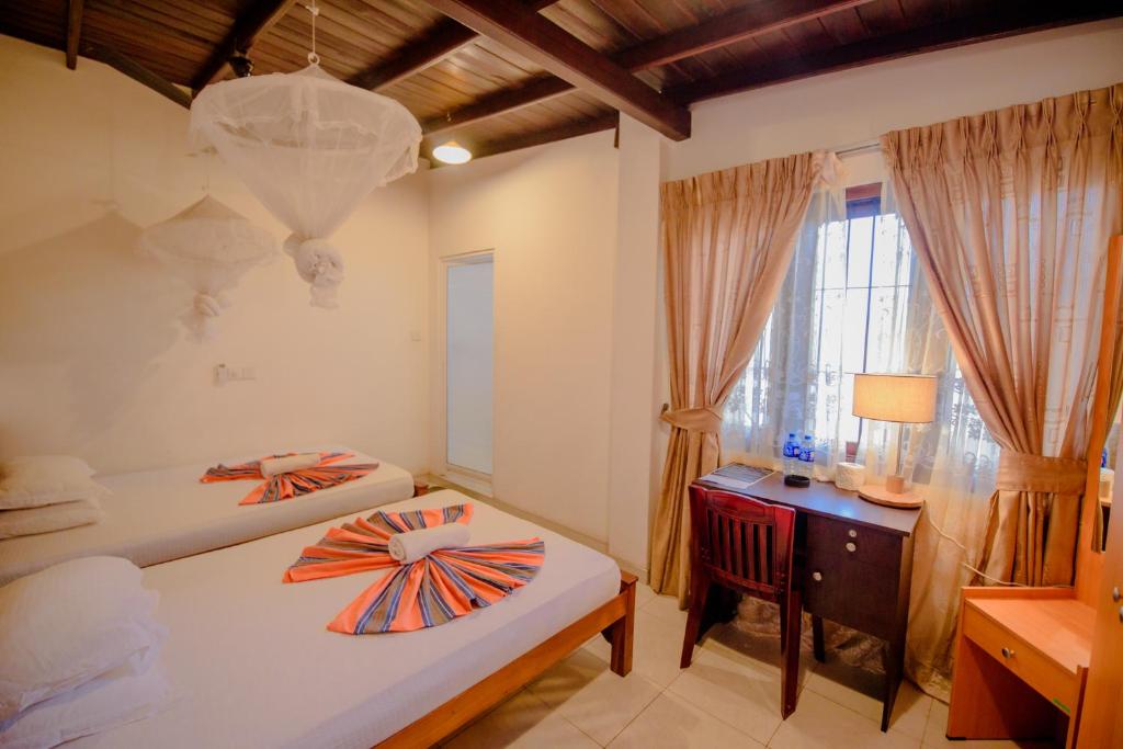 Postel nebo postele na pokoji v ubytování Muhsin Villa - Galle Fort