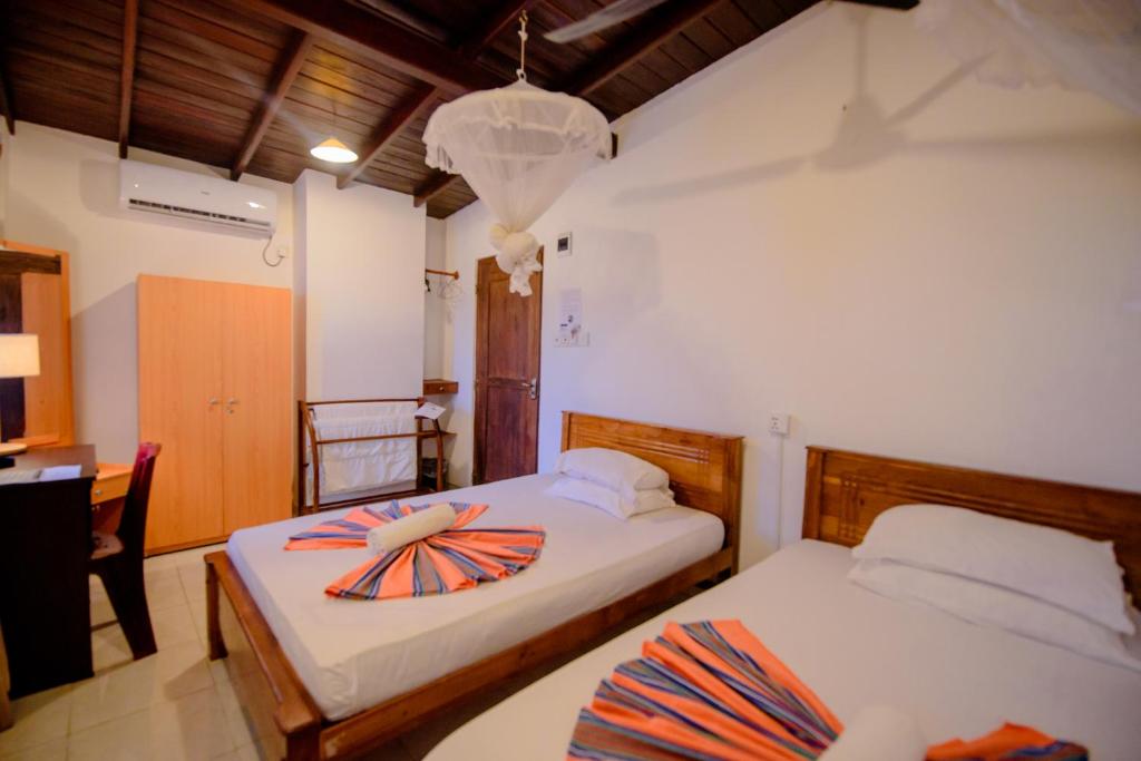 Postel nebo postele na pokoji v ubytování Muhsin Villa - Galle Fort
