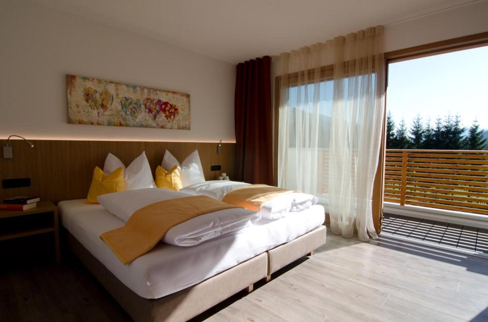 a bedroom with a large bed and a large window at Villa Aylin in Prato alla Drava
