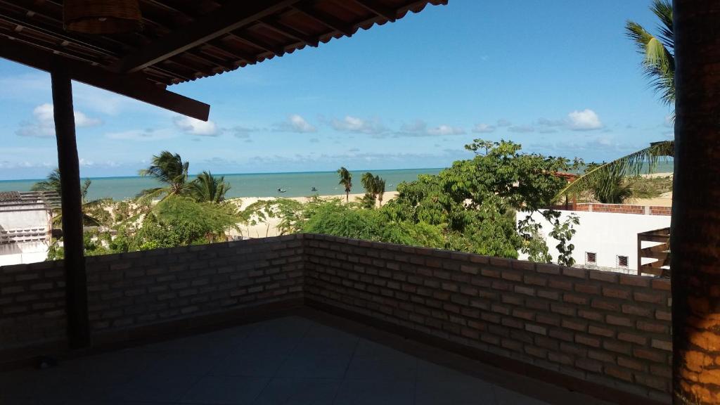 a view of the beach from the balcony of a house at Moringa Beach in São Miguel do Gostoso