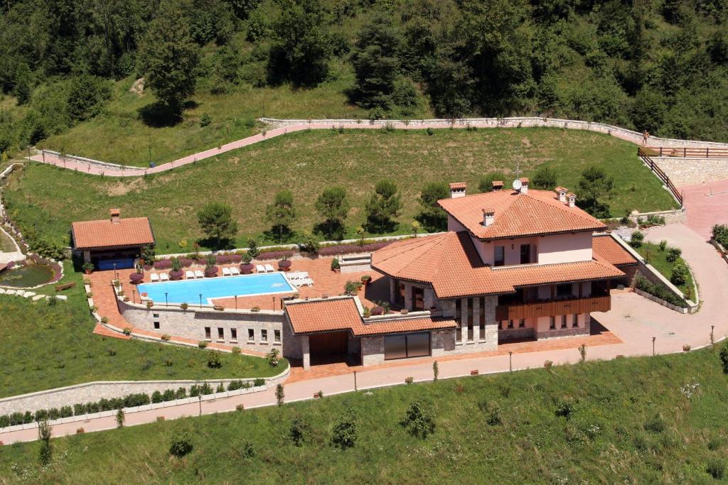 an aerial view of a house with a swimming pool at Resort Ninfea San Pellegrino Terme in San Pellegrino Terme