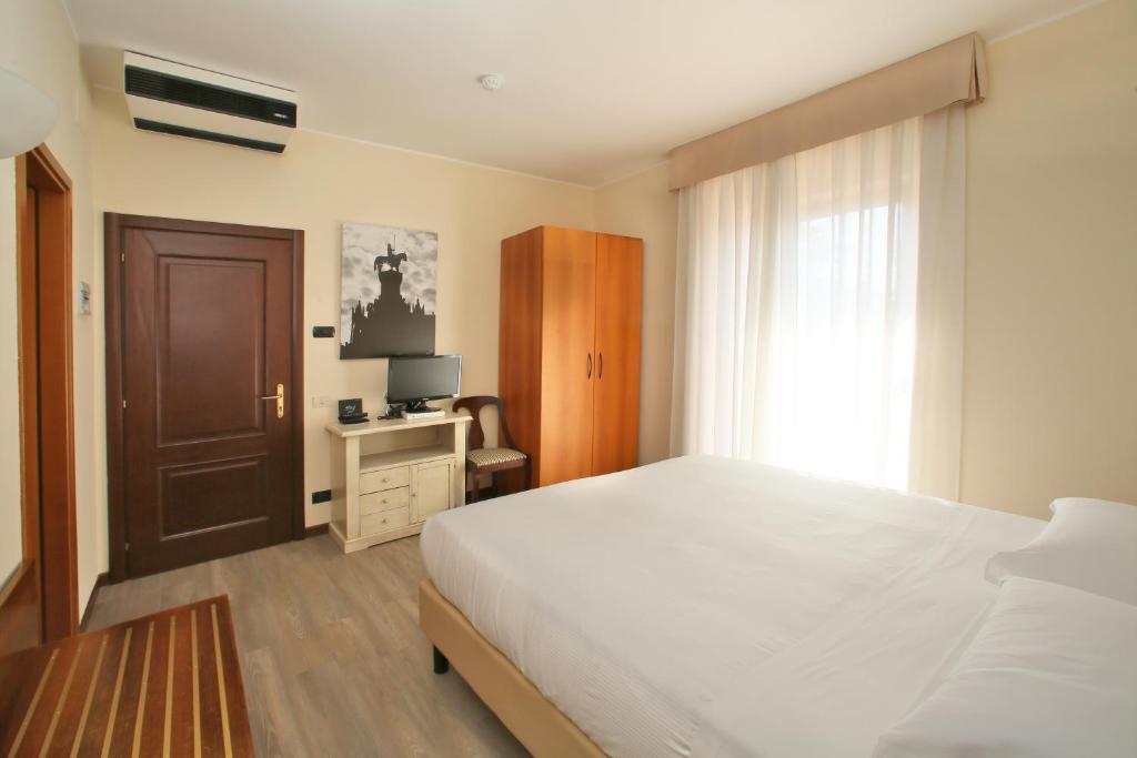 Postel nebo postele na pokoji v ubytování Veronello Resort