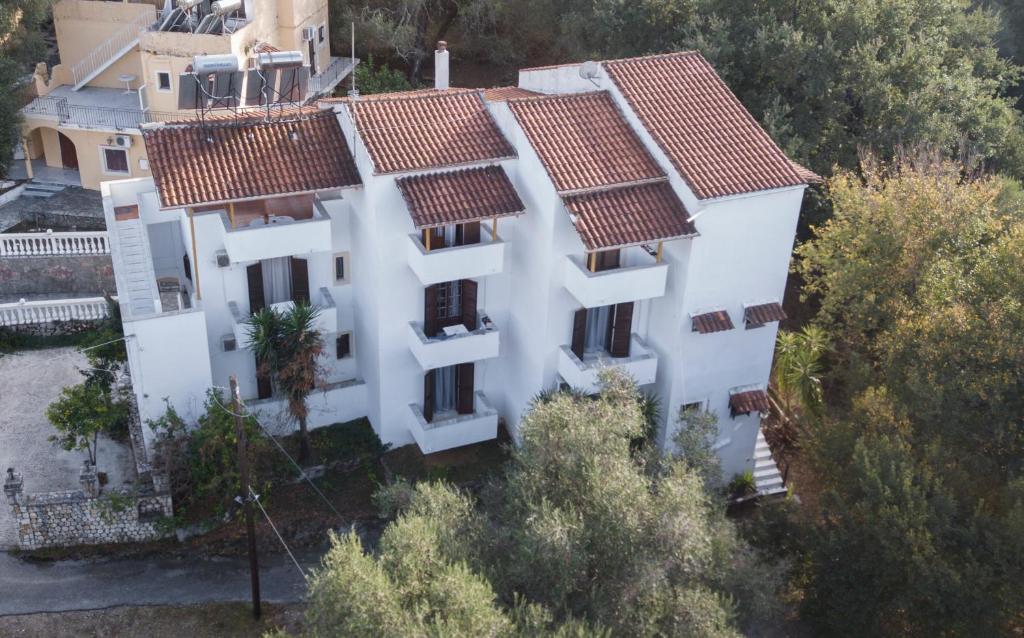 an aerial view of a white house with red roofs at Corfu Room in Áyioi Dhéka