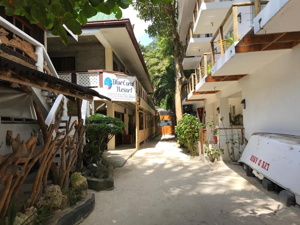 an alley between two buildings with a van parked in front at Blue Coral Resort Boracay in Boracay