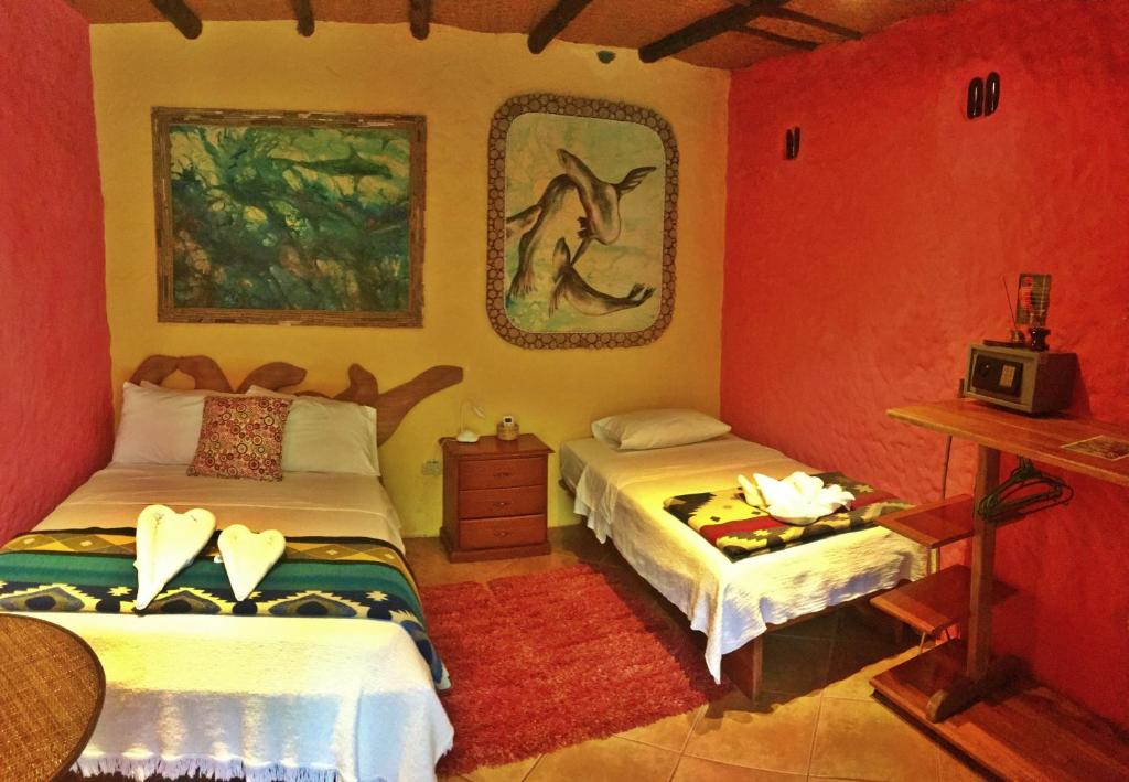 Postel nebo postele na pokoji v ubytování Lonesome George Ecolodge