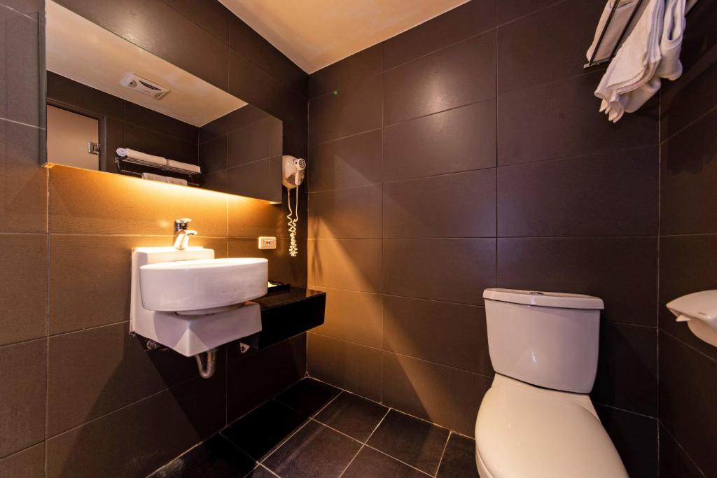 a bathroom with a toilet and a sink at The Riverside Hotel Fashion in Kaohsiung