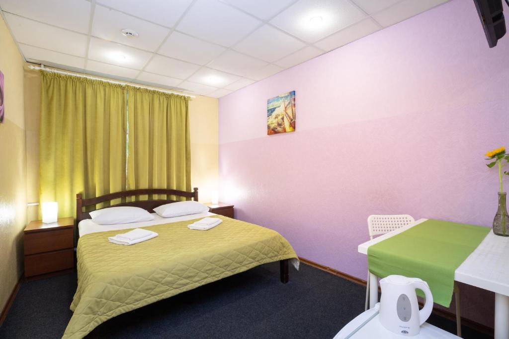 Кровать или кровати в номере Мини-отель Ботанический