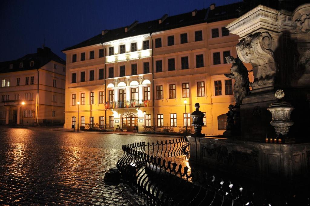 a city street with buildings and a statue in front at Hotel Prince de Ligne in Teplice