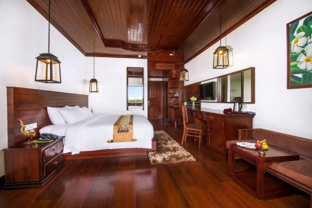 a bedroom with a bed and a desk at Borei Angkor Resort & Spa in Siem Reap