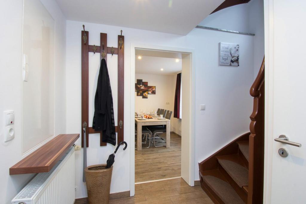 a hallway with a door leading to a bathroom with a sink at Ferienhaus an der Burg Namedy in Andernach
