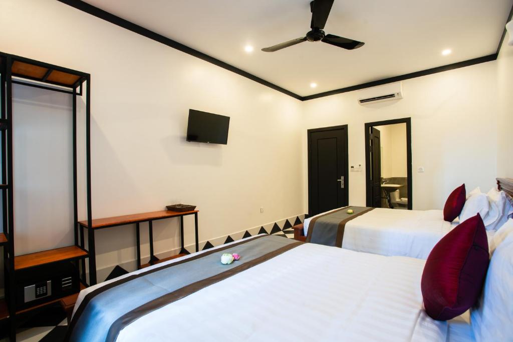 Postel nebo postele na pokoji v ubytování Noni Tree Hostel