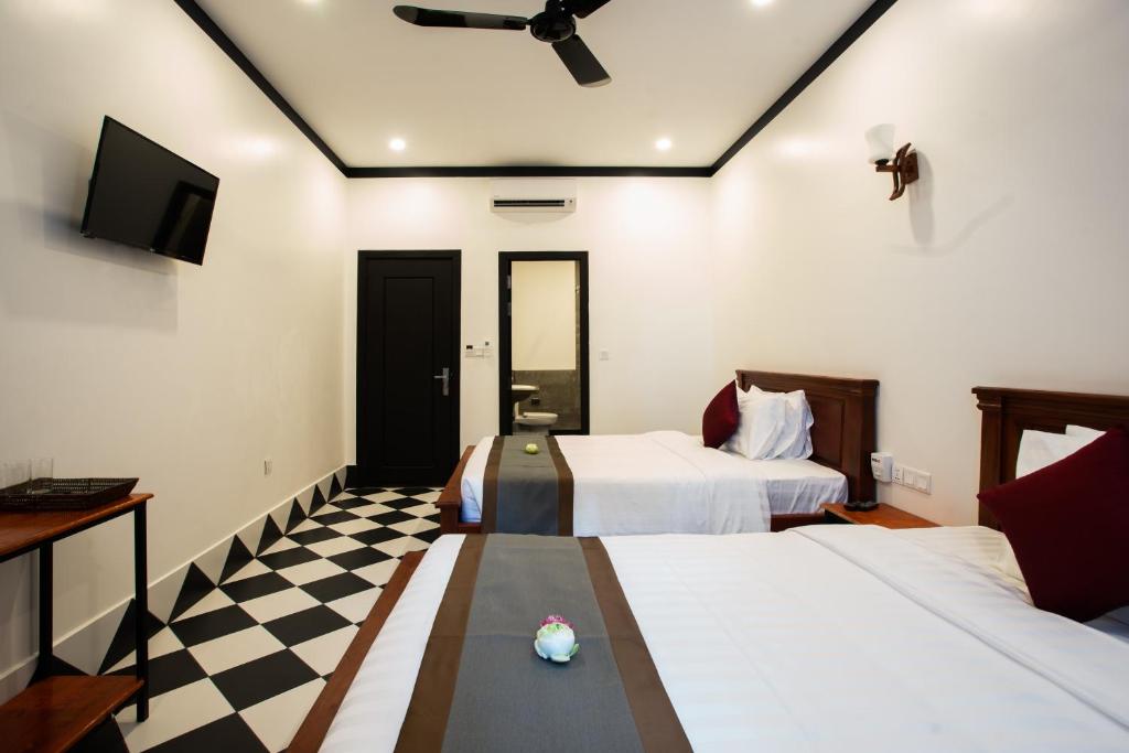 Postel nebo postele na pokoji v ubytování Noni Tree Hostel