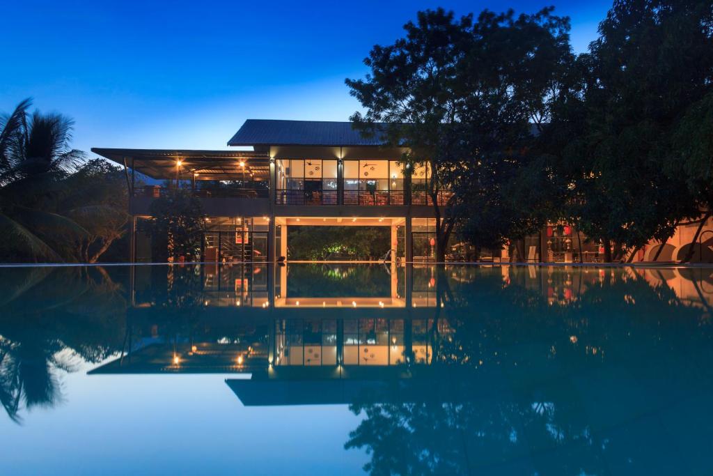 
a large building with a view of the water at Sigiriana Resort by Thilanka in Dambulla
