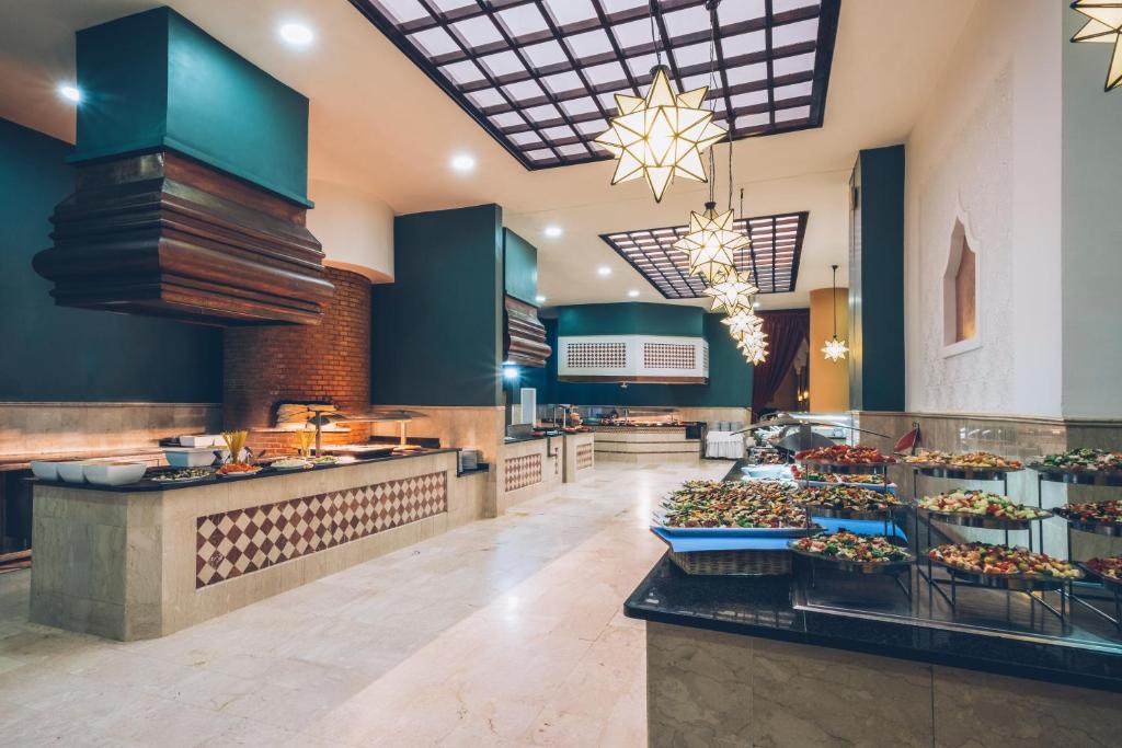 a restaurant with a buffet line with food on display at Iberostar Waves Saidia in Saidia 