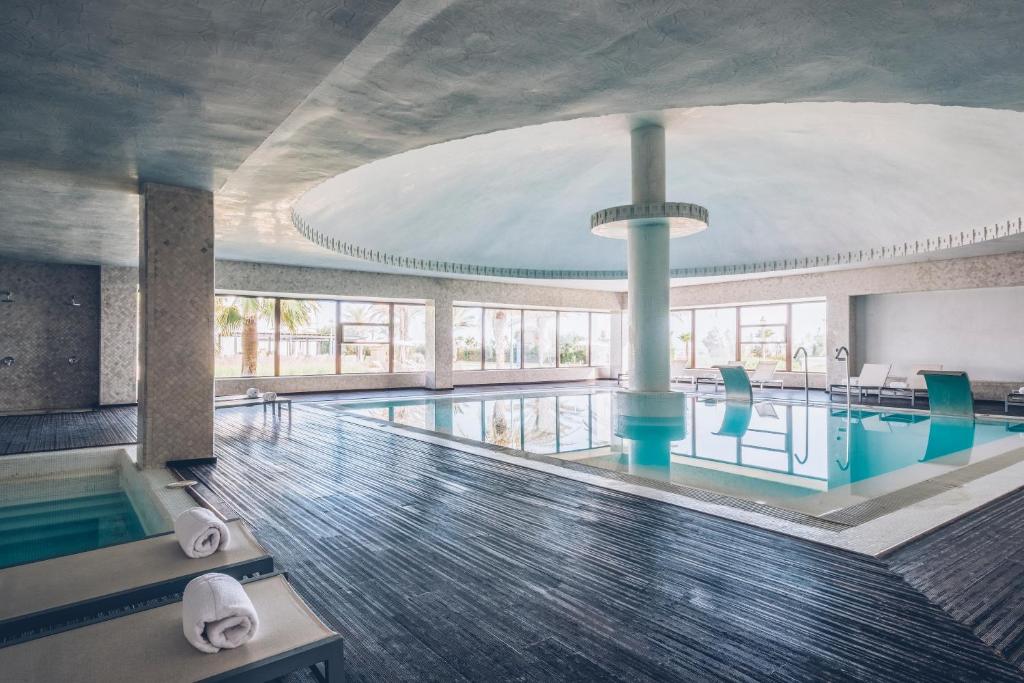a large swimming pool with a large ceiling at Iberostar Waves Saidia in Saidia 