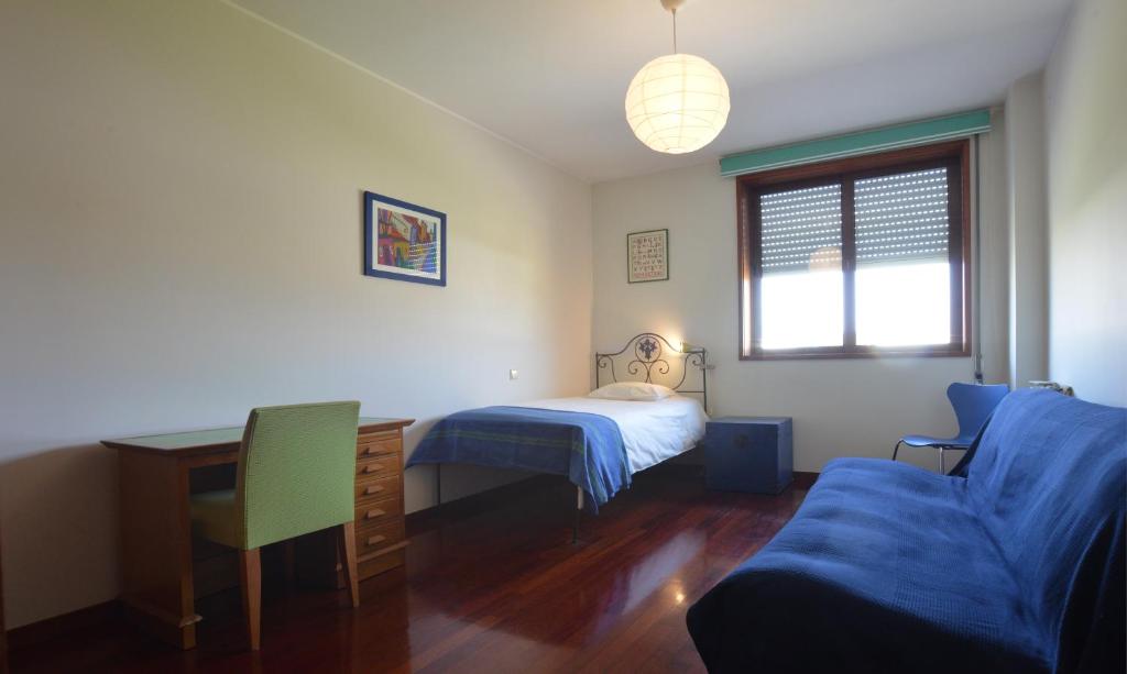 a bedroom with a bed and a desk and a couch at sunset@leçadapalmeira in Matosinhos