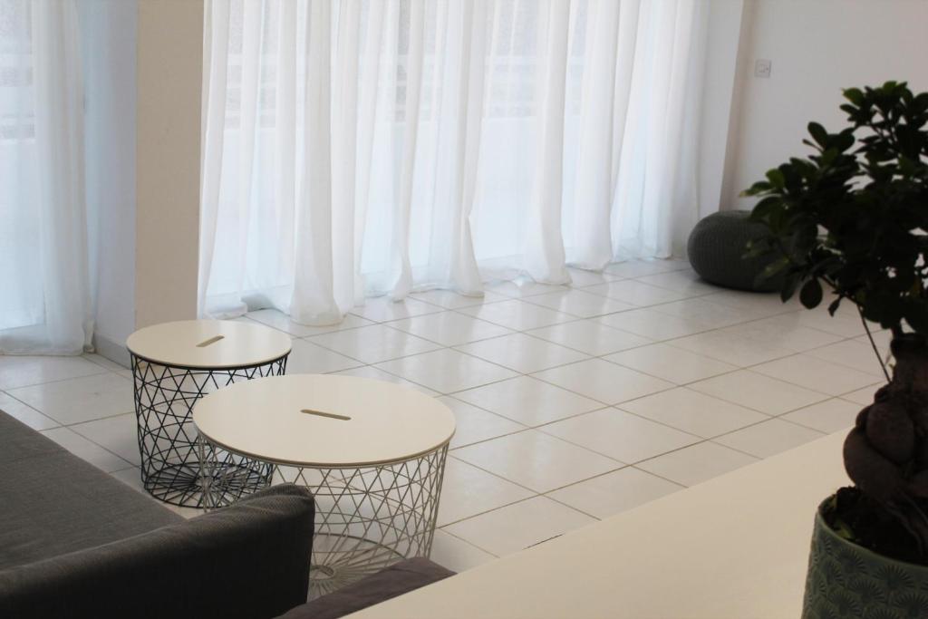 a living room with two tables and a couch at Olosuites in Limassol