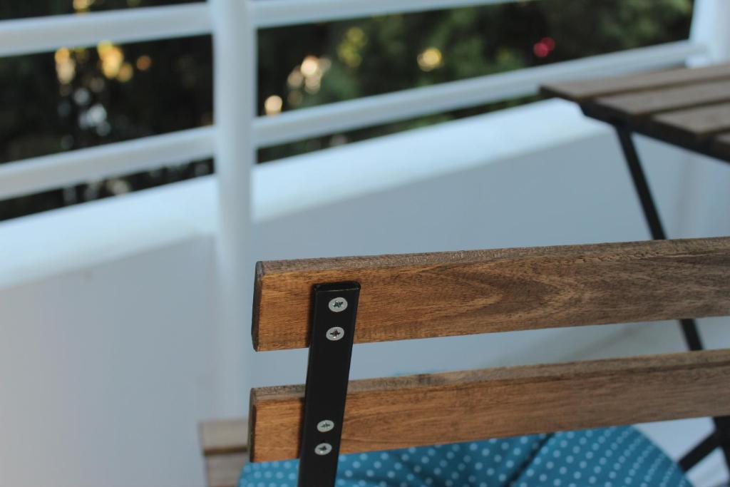 a close up of a wooden bench in front of a window at Olosuites in Limassol