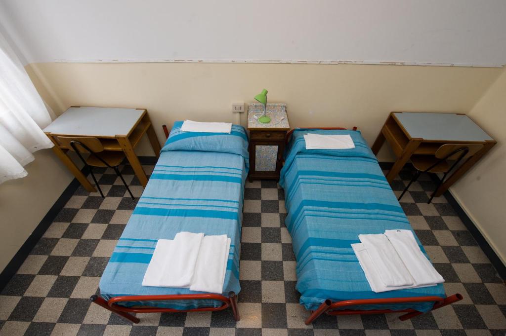 Postel nebo postele na pokoji v ubytování Ostello Domus Civica