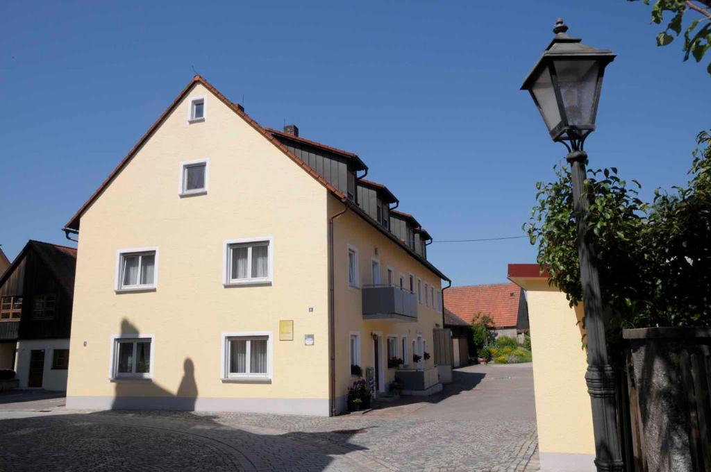 a building with a street light in front of it at Ferienhof Winkler in Merkendorf