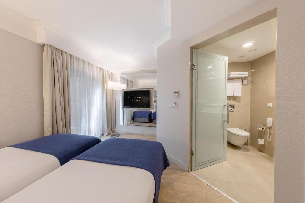 A bed or beds in a room at CVK Taksim Hotel Istanbul