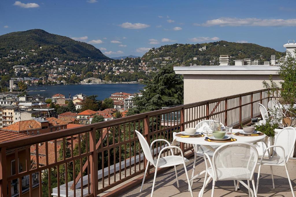 a table and chairs on a balcony with a view at Aerie Esmeralda in Como