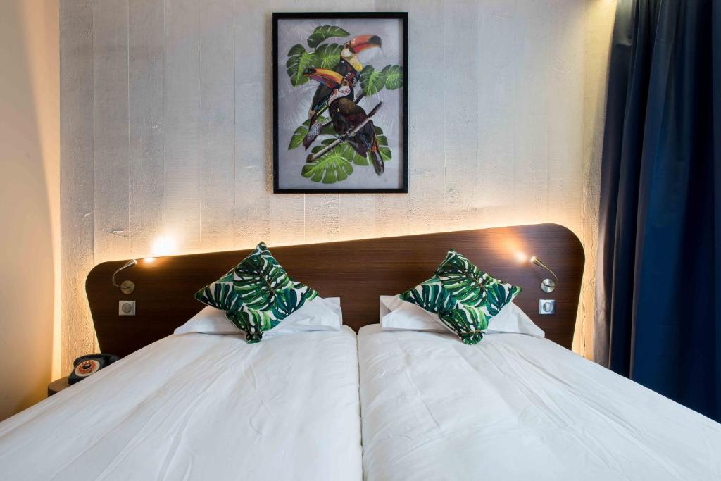 Postel nebo postele na pokoji v ubytování KOPSTER Hotel Lyon Groupama Stadium