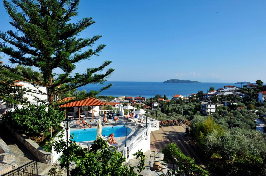 a view of a resort with a swimming pool and the ocean at Fengeros Village in Megali Ammos