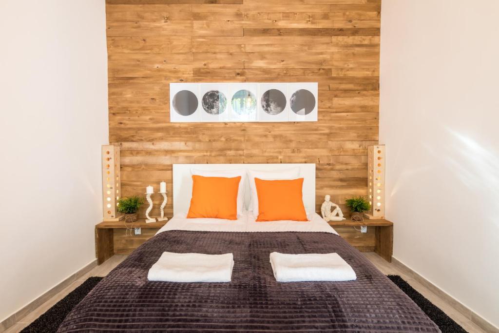 una camera da letto con un grande letto con cuscini arancioni di Cracow Best Location Apartment with Garden by Cozyplace a Cracovia