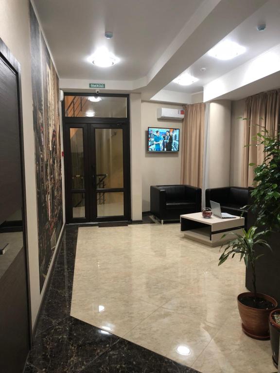 a lobby with a living room with a couch and a table at Kechkemet Hotel in Simferopol