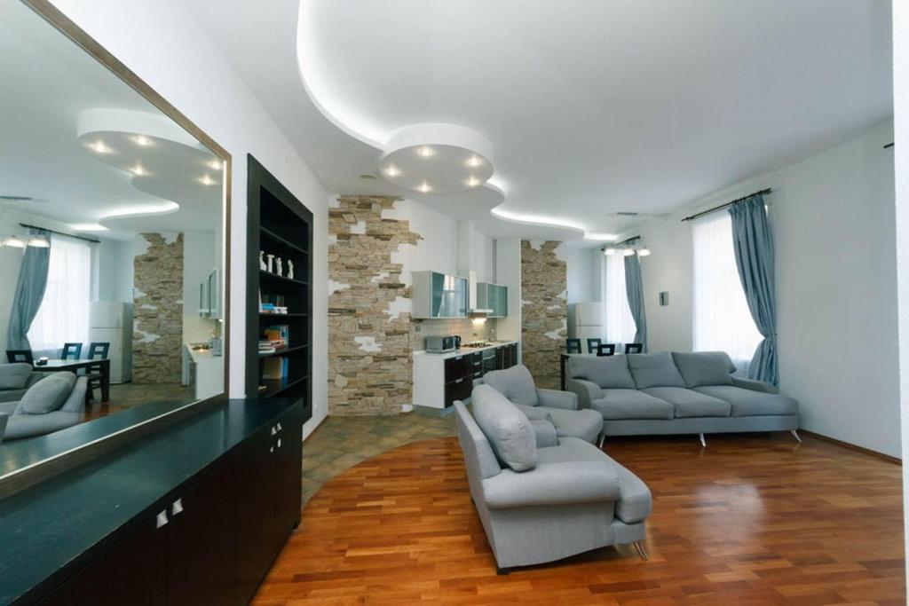 a living room with two couches and a tv at LUX near Maidan, Khreschutyk 3BR in Kyiv