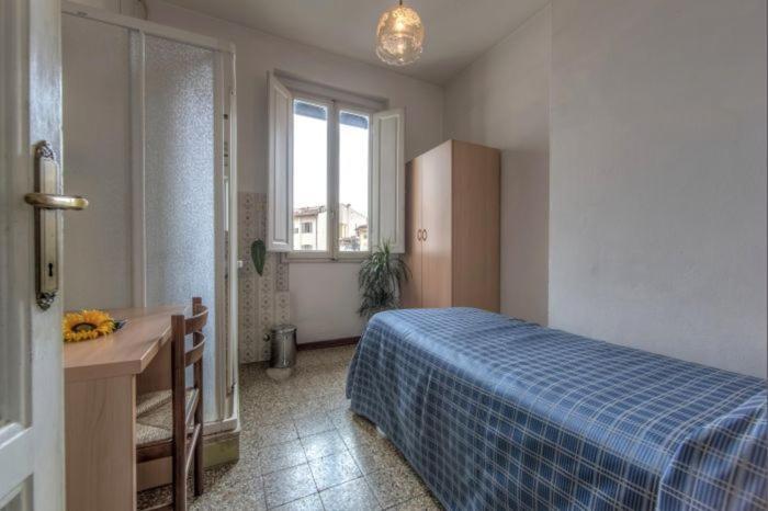 A bed or beds in a room at Hotel Aldobrandini
