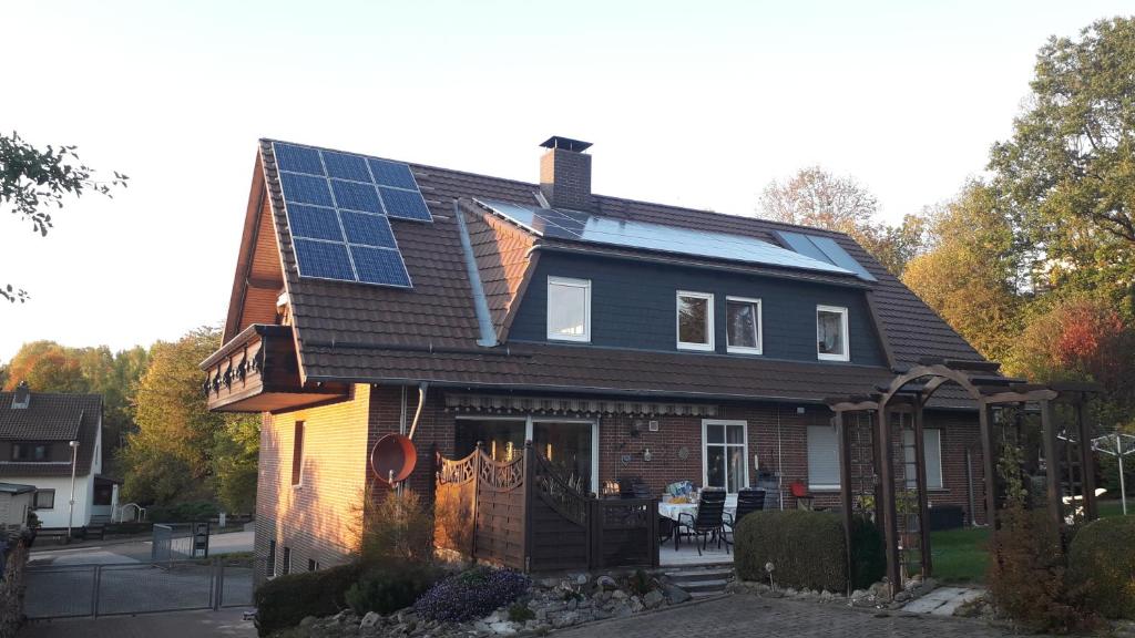 a house with solar panels on the roof at Ferienwohnung Mai in Gittelde