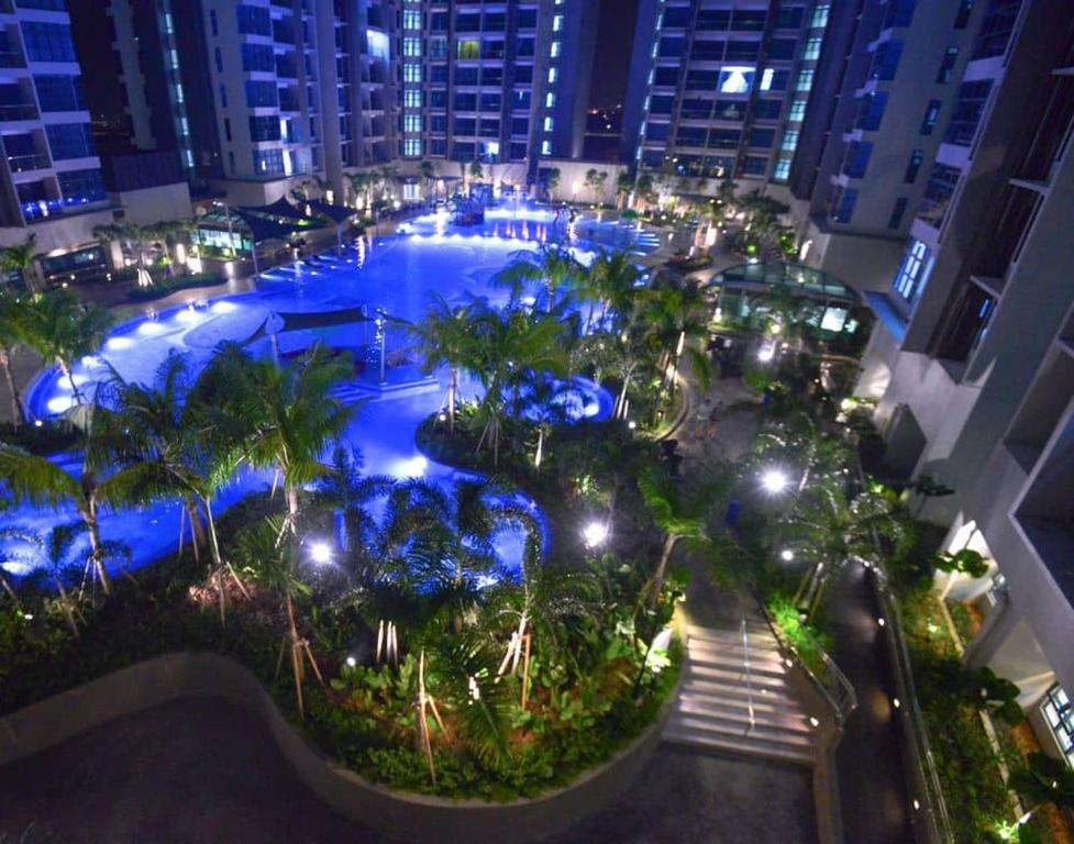 an overhead view of a swimming pool at night at Atlantis Residences Malacca City by Nestcove in Melaka