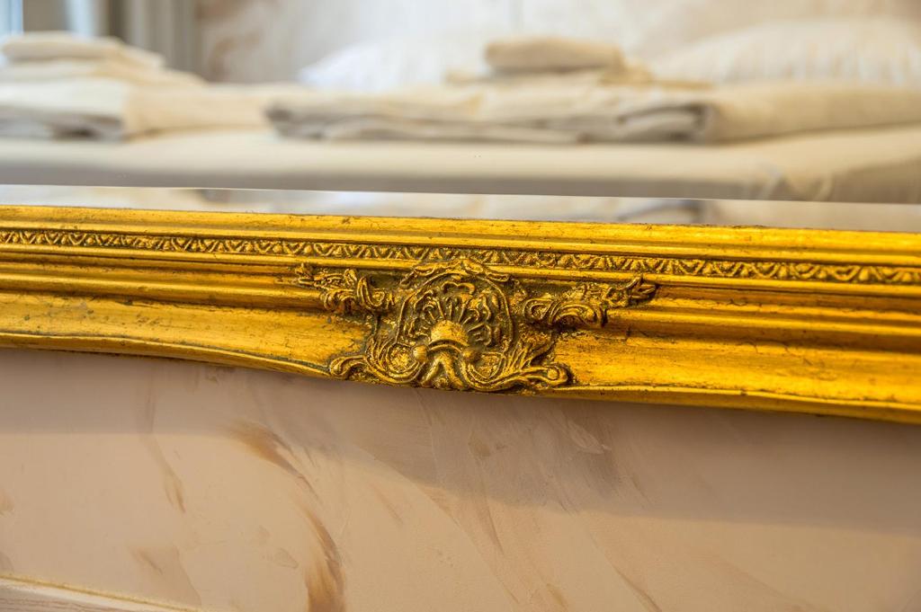 a gold mirror on a table in a room at Vintage Apartment in Cologne