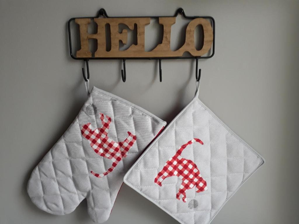 two towels hanging from a hilt on a wall at Gîte " Le Vieux Noyer" in Liesville-sur-Douve