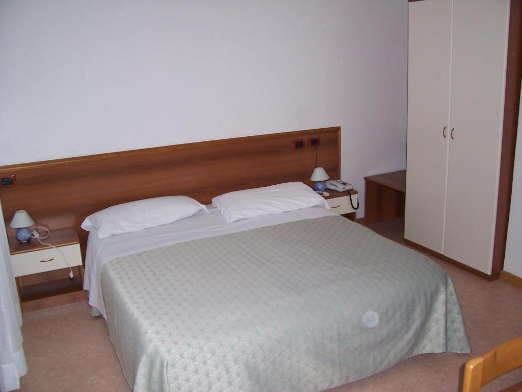 Postel nebo postele na pokoji v ubytování Hotel Clodia